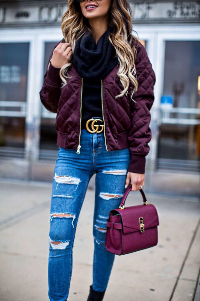 fashion blogger mia mia mine wearing a gucci belt and a burgundy mini bag by henri bendel