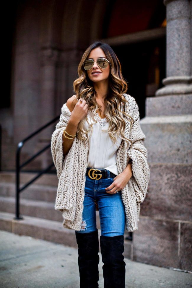fashion blogger mia mia mine wearing a cable knit wrap and gucci double g buckle belt