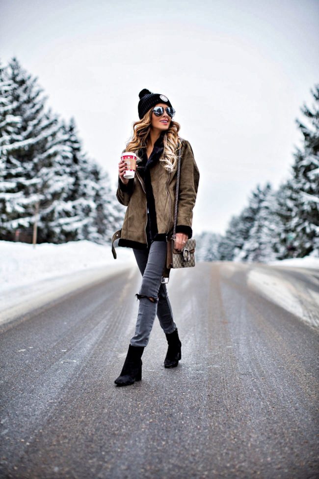 fashion blogger mia mia mine wearing a shearling jacket and gray jeans from nordstrom