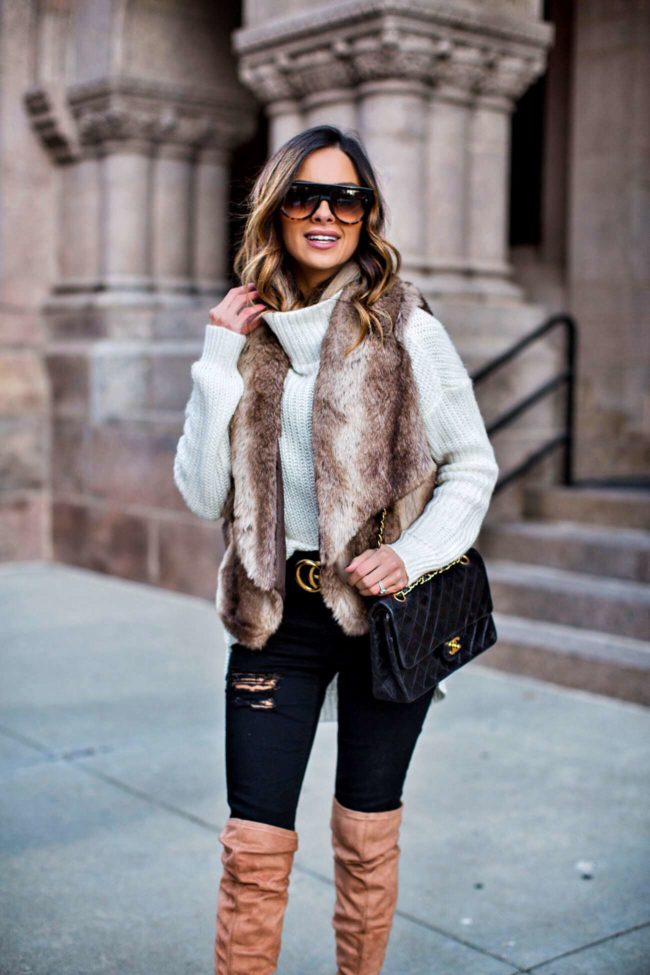 fashion blogger mia mia mine wearing a faux fur vest and a gucci double g belt from nordstrom