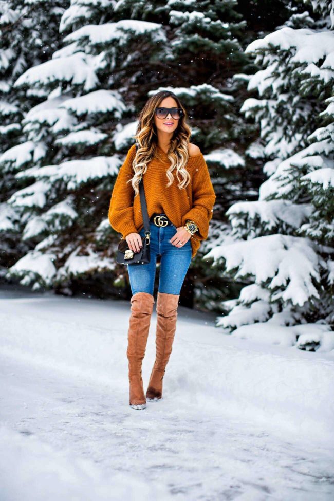 fashion blogger mia mia mine wearing steve madden over-the-knee boots and an orange off-the-shoulder sweater from nordstrom