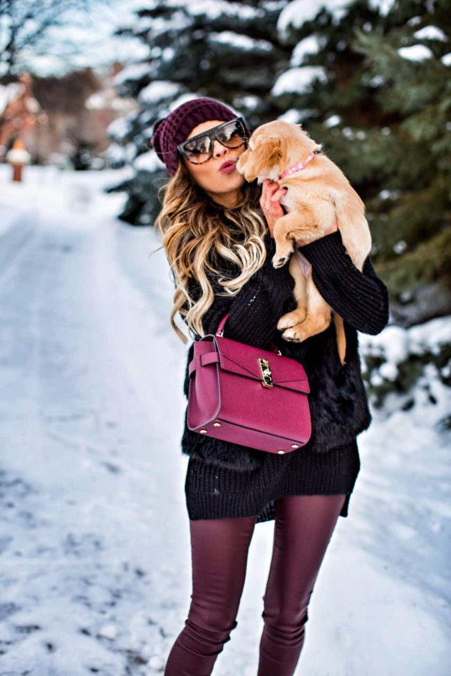 fashion blogger mia mia mine wearing a winter outfit from nordstrom and holding a golden retriever puppy