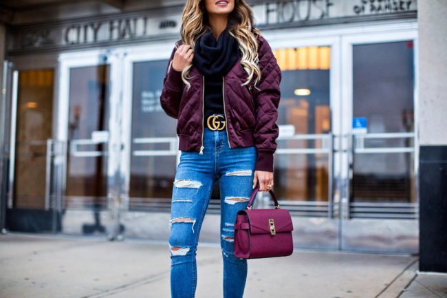 fashion blogger mia mia mine wearing an express burgundy bomber jacket and a burgundy mini bag from henri bendel