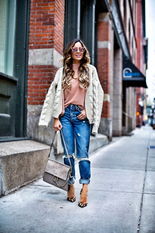 fashion blogger mia mia mine wearing a pink top from revolve and grlfrnd jeans from revolve