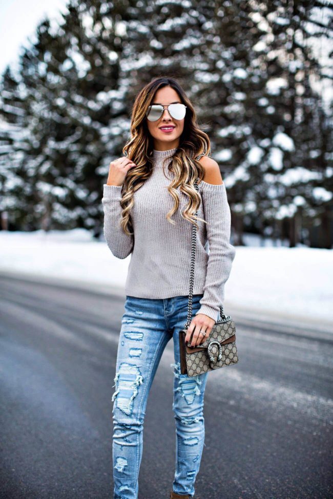 fashion blogger mia mia mine wearing a cold-shoulder sweater from express and ripped jeans