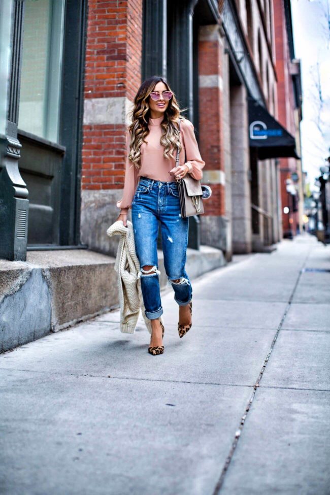 mn fashion blogger mia mia mine wearing a pink top from revolve and distressed jeans