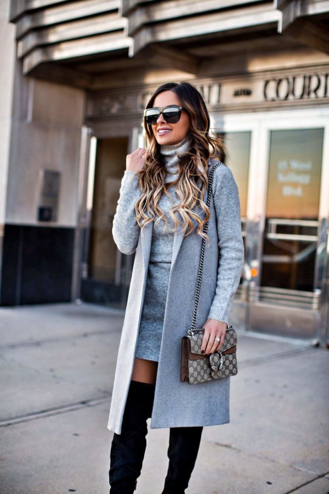 fashion blogger mia mia mine wearing a gray sweater dress from asos and black over-the-knee boots from nordstrom