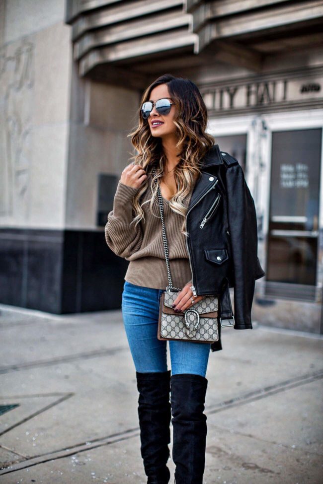 fashion blogger mia mia mine wearing a leather jacket and black over-the-knee boots