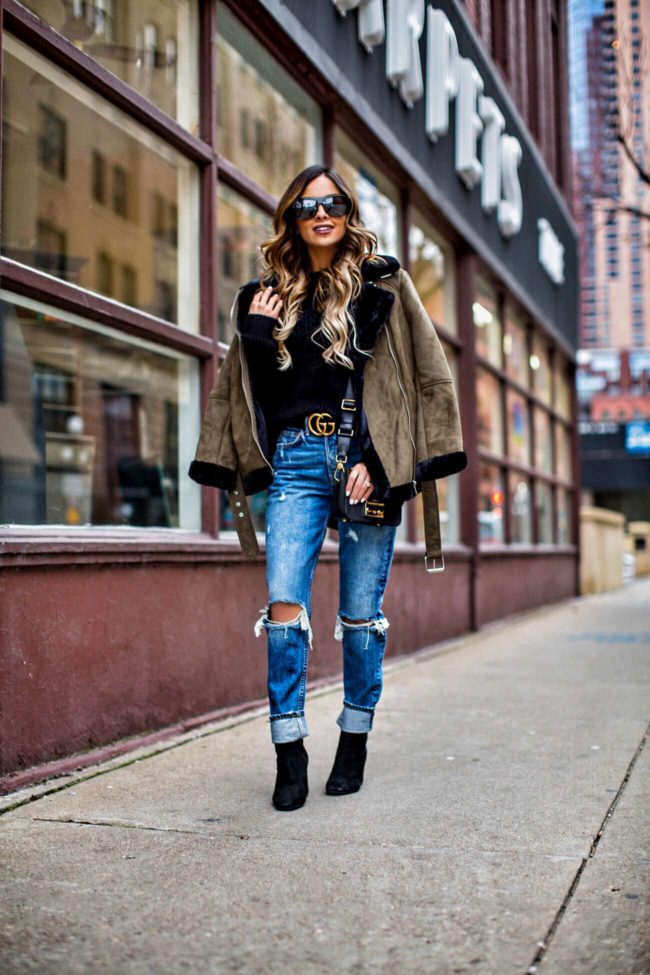 fashion blogger mia mia mine wearing a shearling jacket by topshop and grlfrnd jeans from revolve