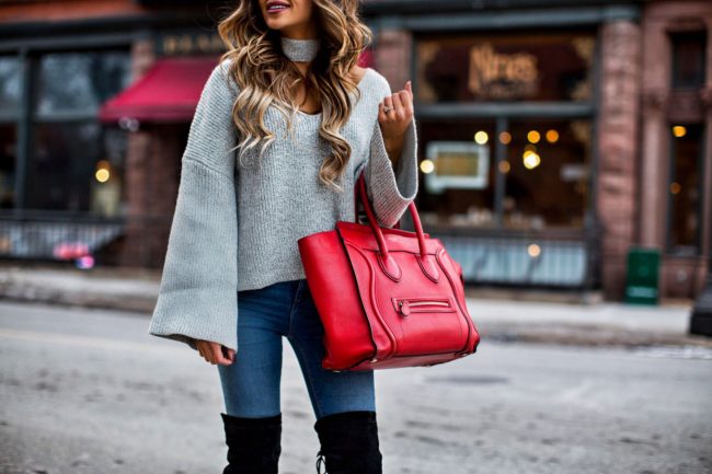 fashion blogger mia mia mine wearing a v-neck sweater by english laundry and a celine red bag