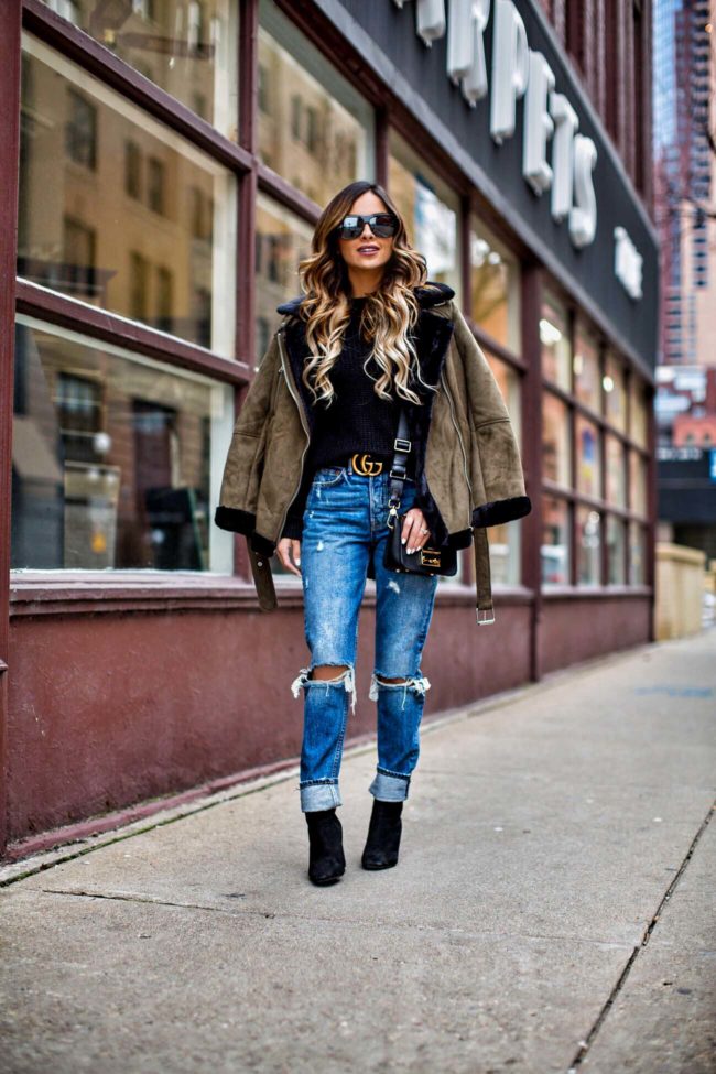 fashion blogger mia mia mine wearing a shearling jacket from topshop and grlfrnd jeans from revolve