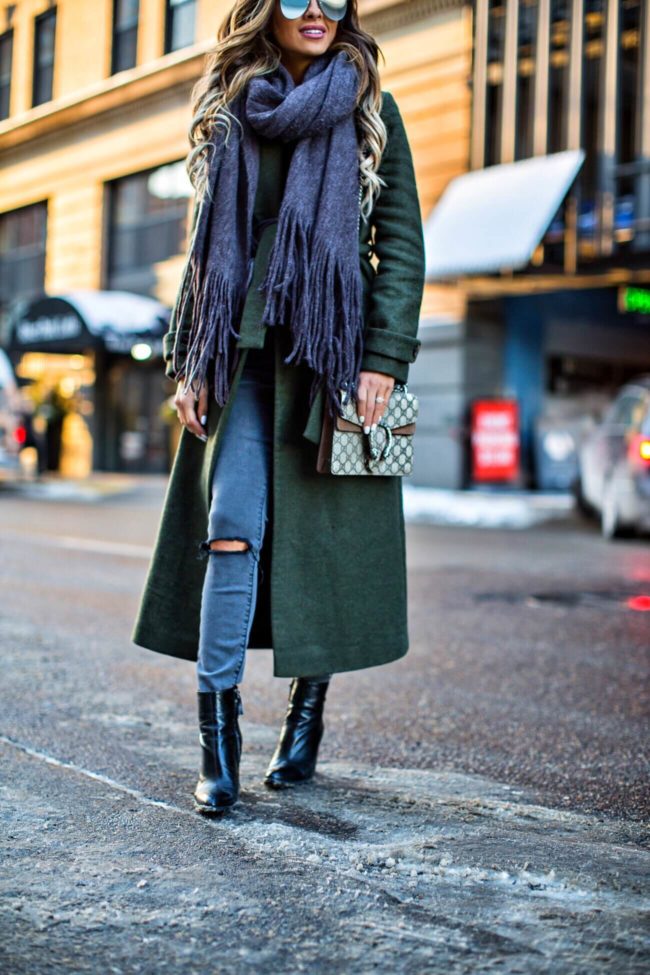 mn fashion blogger mia mia mine wearing a green trench coat and gray jeans from asos