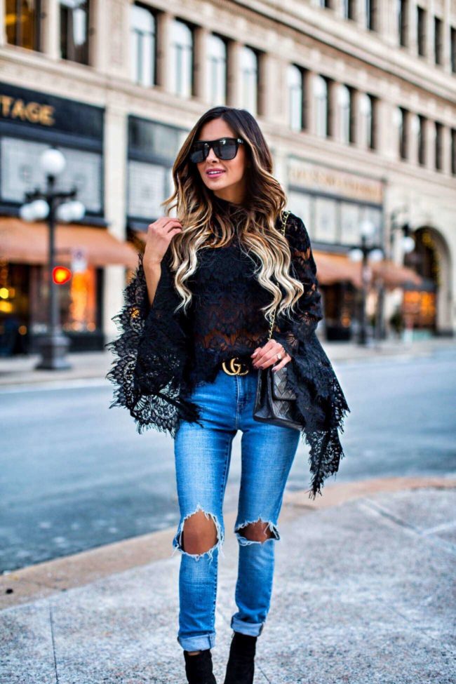 mn fashion blogger mia mia mine wearing a lace bell sleeve top from revolve and levi's distressed jeans