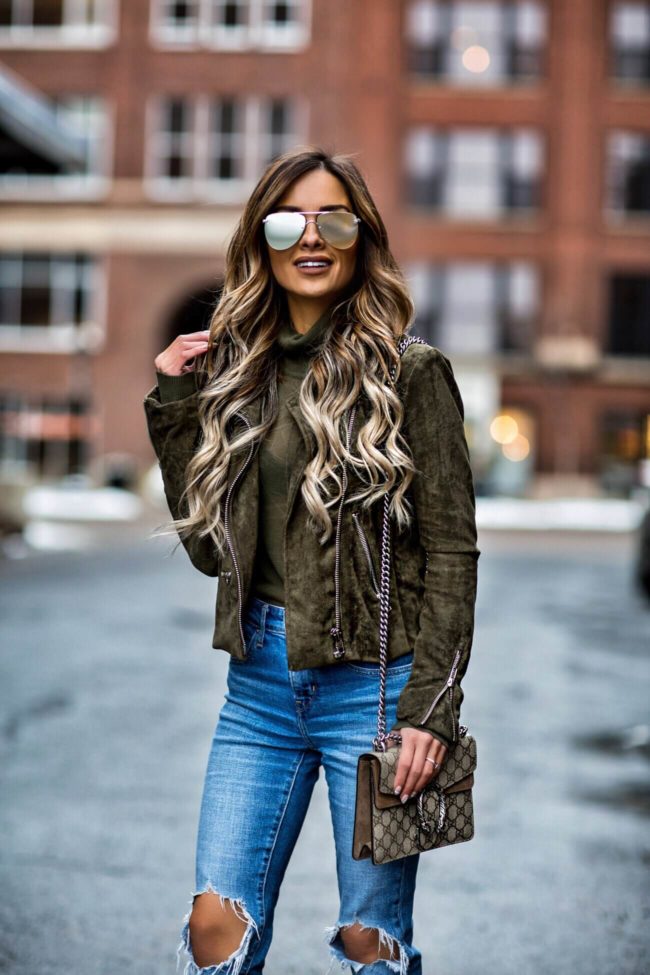 fashion blogger mia mia mine wearing an olive suede blanknyc jacket and levi's jeans