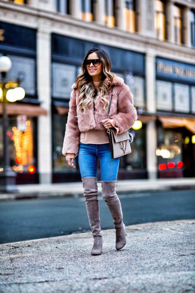 fashion blogger mia mia mine wearing a blush faux fur jacket and a chloe faye medium bag
