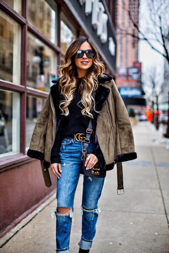 mn fashion blogger mia mia mine wearing a black turtleneck sweater and ripped jeans from revolve