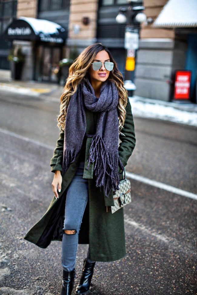 mn fashion blogger mia mia mine wearing a green trench coat and a free people scarf 