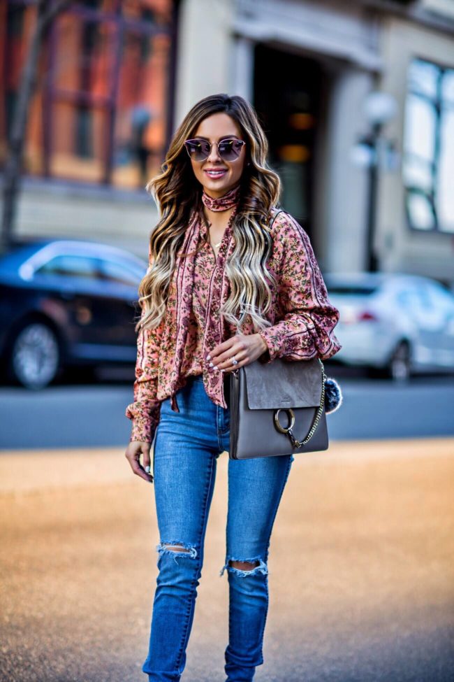 fashion blogger mia mia mine wearing a pink floral print top by free people from revolve