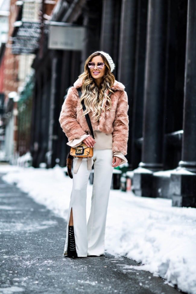 fashion blogger mia mia mine wearing a blush faux fur jacket and public desire booties in soho new york
