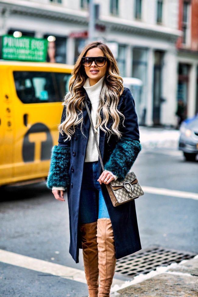 fashion blogger mia mia mine wearing a faux fur winter coat in NYC at NYFW