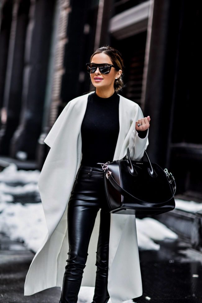 fashion blogger mia mia mine wearing a white trench coat and black bodysuit at new york fashion week February 2017