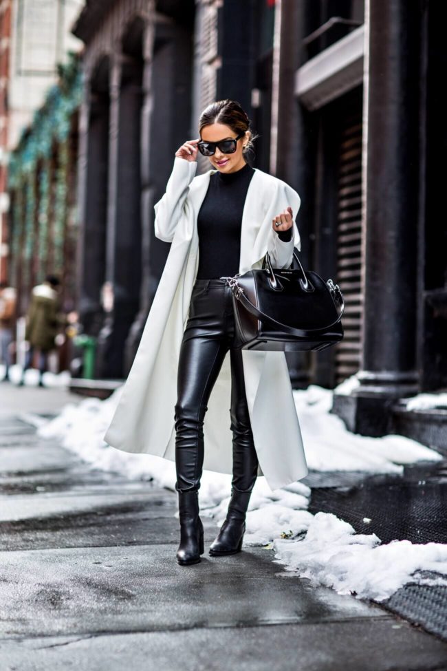fashion blogger mia mia mine wearing a white trench coat by missguided and black leather pants in soho at nyfw