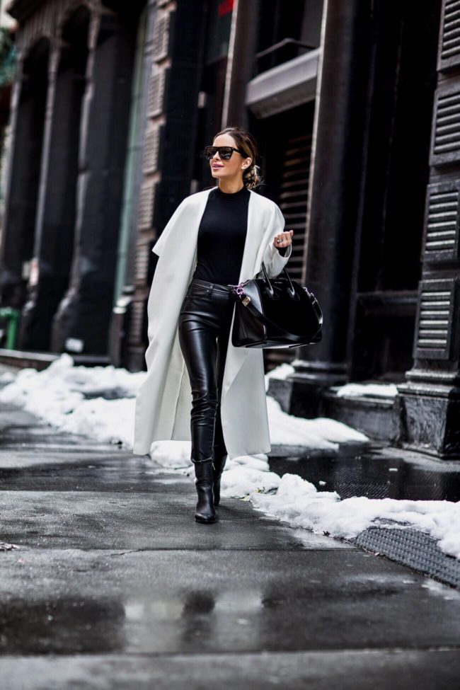 fashion blogger mia mia mine wearing a white coat by missguided and black leather blanknyc pants at nyfw 2017