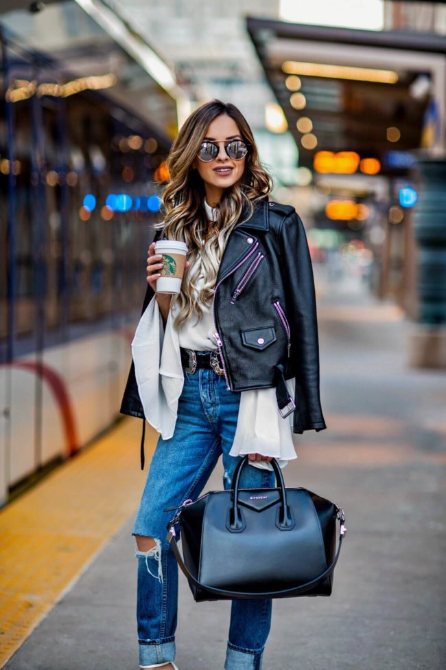 fashion blogger mia mia mine wearing a leather jacket from nordstrom and a white romantic top from shopbop and illesteva sunglasses