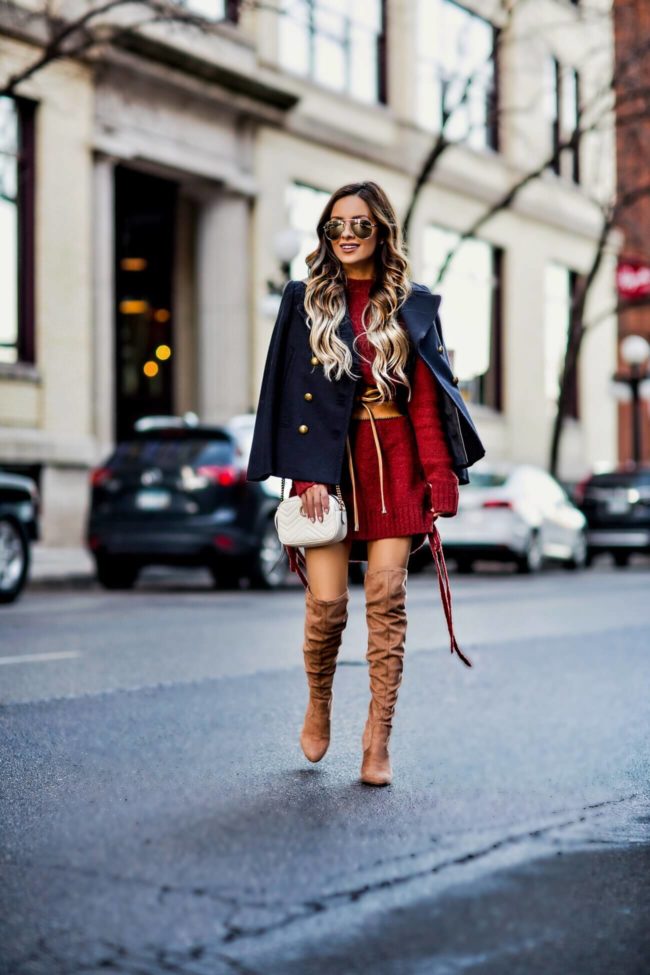 fashion blogger mia mia mine wearing a lace-up sweater dress by lovers + friends from revolve and steve madden over-the-knee boots from nordstrom