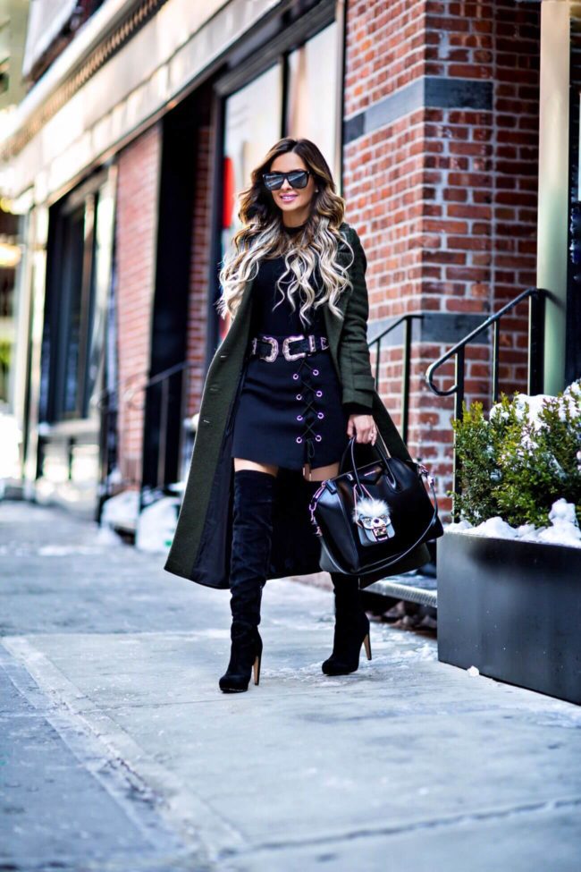 fashion blogger mia mia mine wearing a green trench coat from asos and black over-the-knee boots from nordstrom