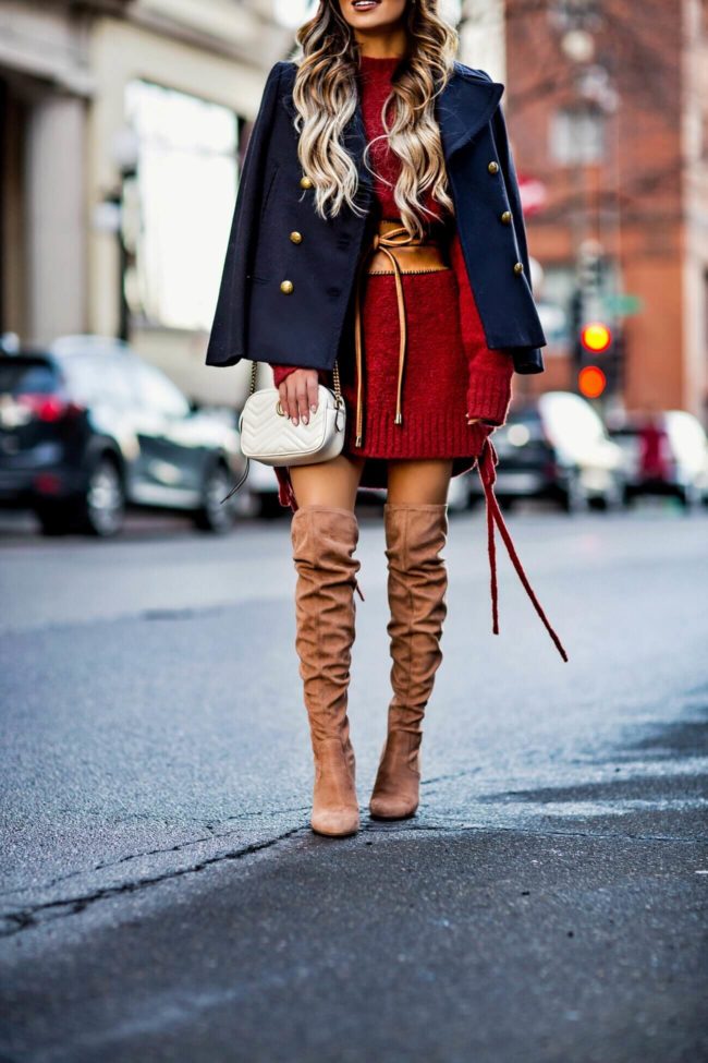 fashion blogger mia mia mine wearing a lace-up sweater dress by lovers + friends from revolve and camel over-the-knee boots from nordstrom