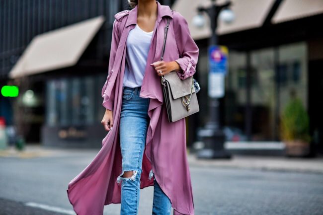 fashion blogger mia mia mine wearing a pink trench coat and ripped jeans