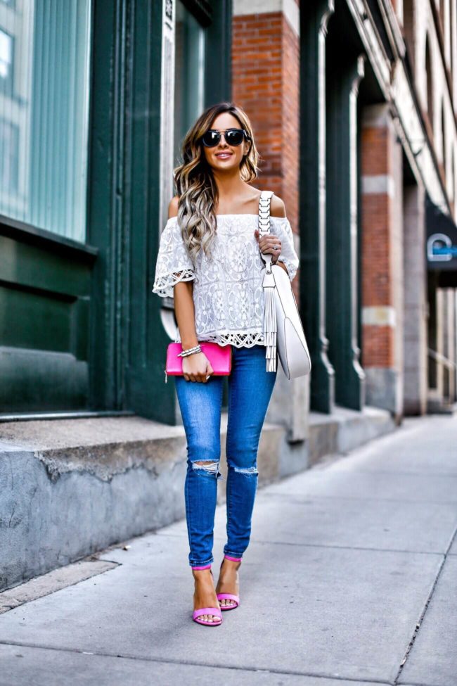 mn fashion blogger mia mia mine wearing a white lace top and pink henri bendel wallet