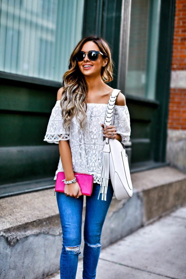 mn fashion blogger mia mia mine wearing a white lace off-the-shoulder top and pink wallet from henri bendel