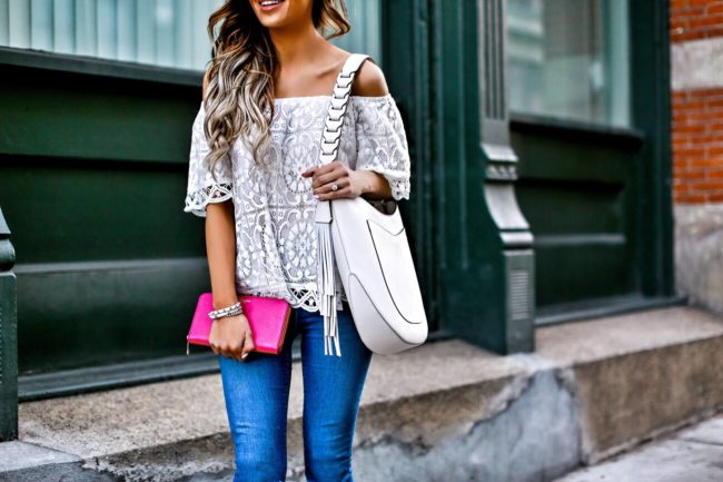 fashion blogger mia mia mine wearing a white lace top and henri bendel white west 57th hobo bag