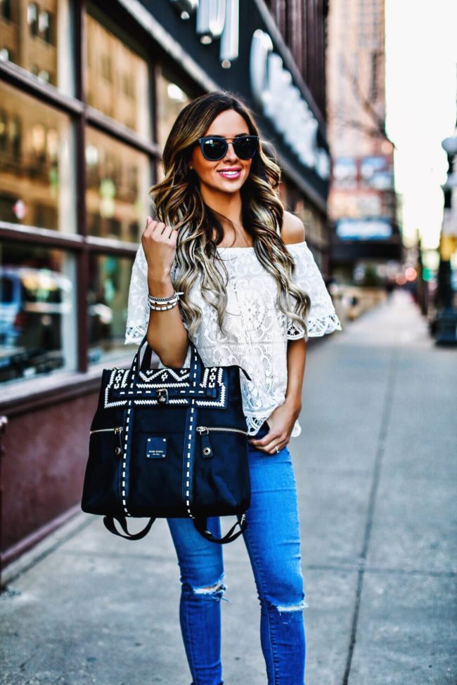 mn fashion blogger mia mia mine carrying a henri bendel bag and wearing a lace top from shopbop