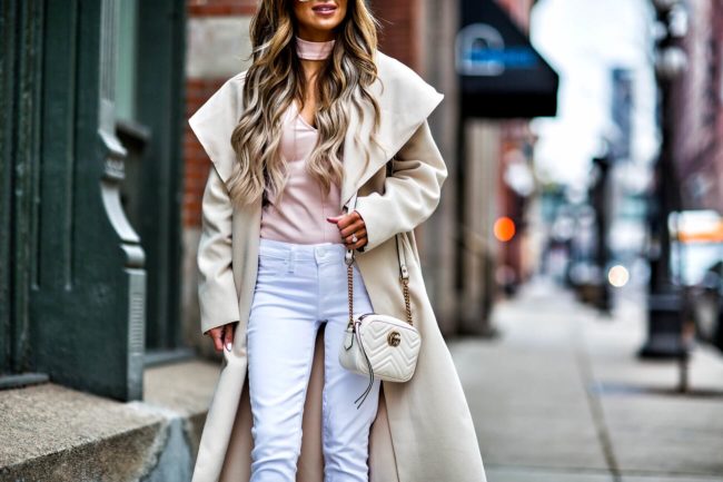 fashion blogger mia mia mine wearing white jeans and a camel coat