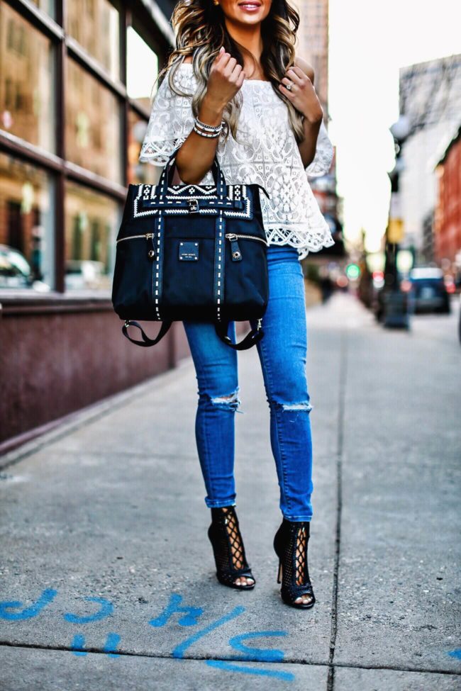 fashion blogger mia mia mine carrying a henri bendel whipstitch jetsetter backpack