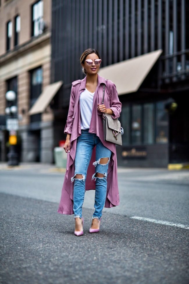 fashion blogger mia mia mine wearing a pink trench coat and ripped jeans from revolve