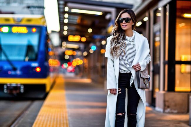 fashion blogger mia mia mine wearing a white coat and a striped top from shopbop