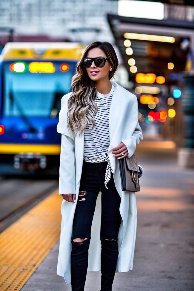fashion blogger mia mia mine wearing a striped top and black ripped jeans from topshop