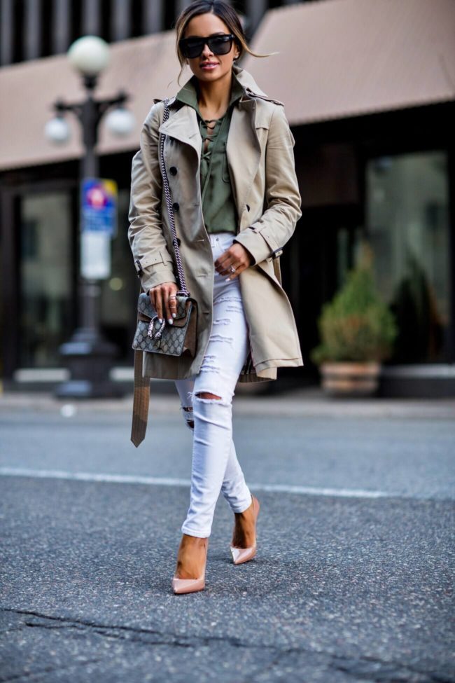 fashion blogger mia mia mine wearing a lace-up olive top and burberry trench coat