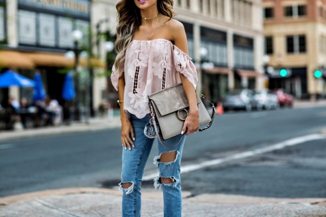 fashion blogger mia mia mine wearing a pink lace lovers + friends top and ripped jeans from revolve