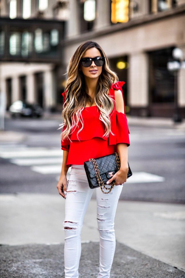 fashion blogger mia mia mine wearing a red bow top from shopbop and a chanel 2.55 bag