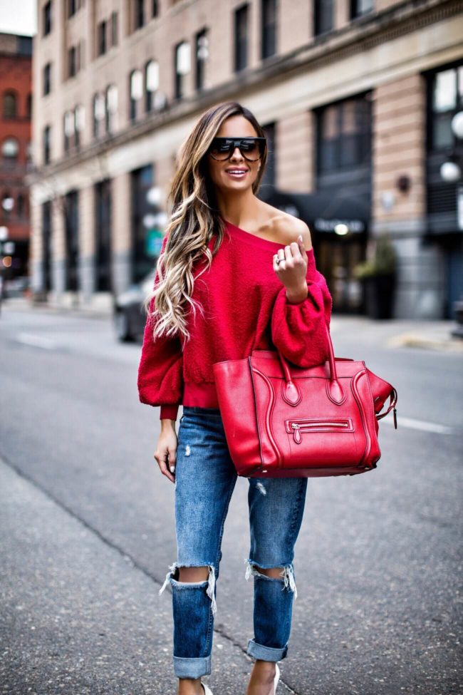 fashion blogger mia mia mine wearing a red off-the-shoulder sweatshirt from nordstrom and a celine bag