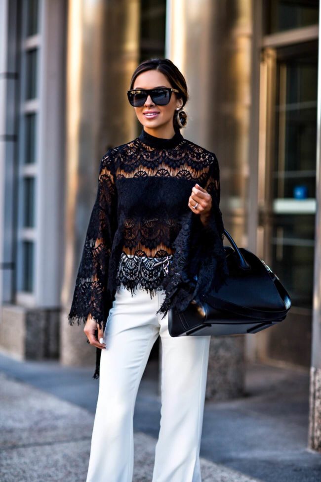 mn fashion blogger mia mia mine wearing a black lace minkpink top and lovers+ friends white pants from revolve