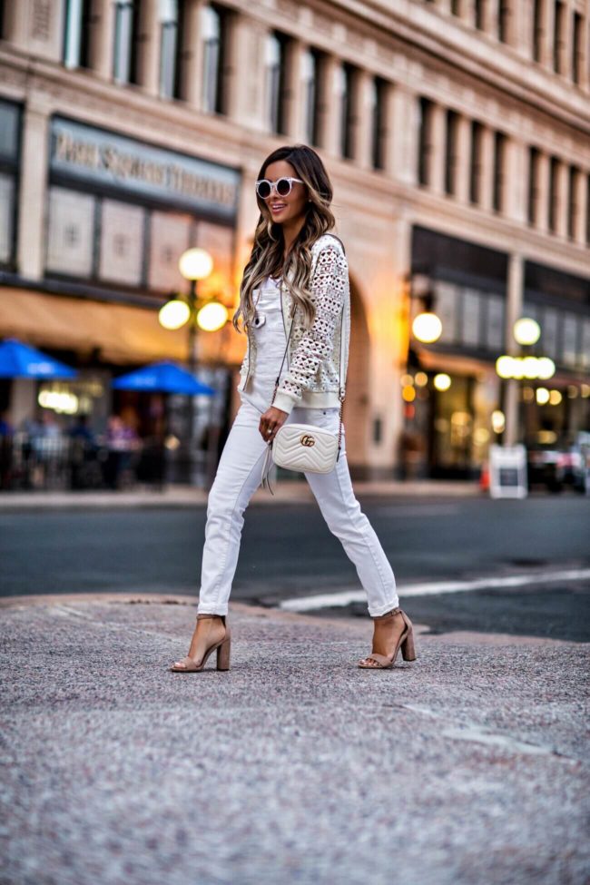 fashion blogger mia mia mine wearing a white lace bomber jacket and white free people overalls