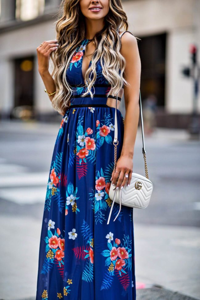 fashion blogger mia mia mine wearing a blue floral maxi dress from express