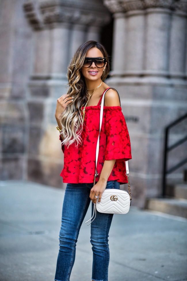 fashion blogger mia mia mine wearing a red lace top and celine sunglasses