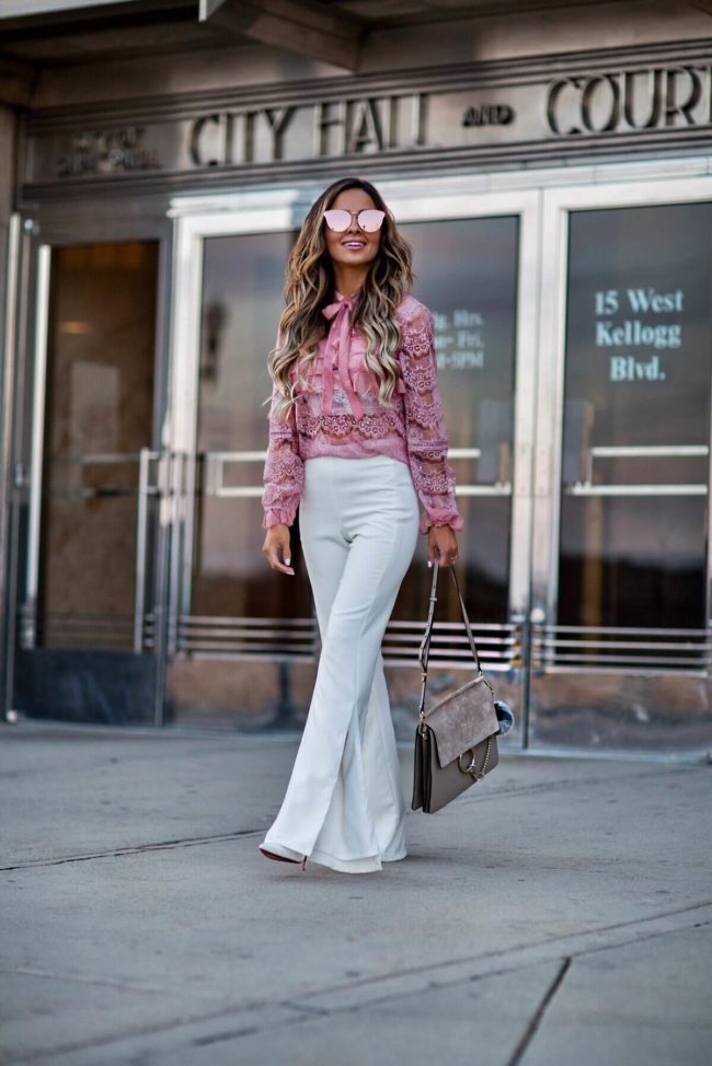 mn fashion blogger mia mia mine wearing a pink lace shopbop top and white revolve pants